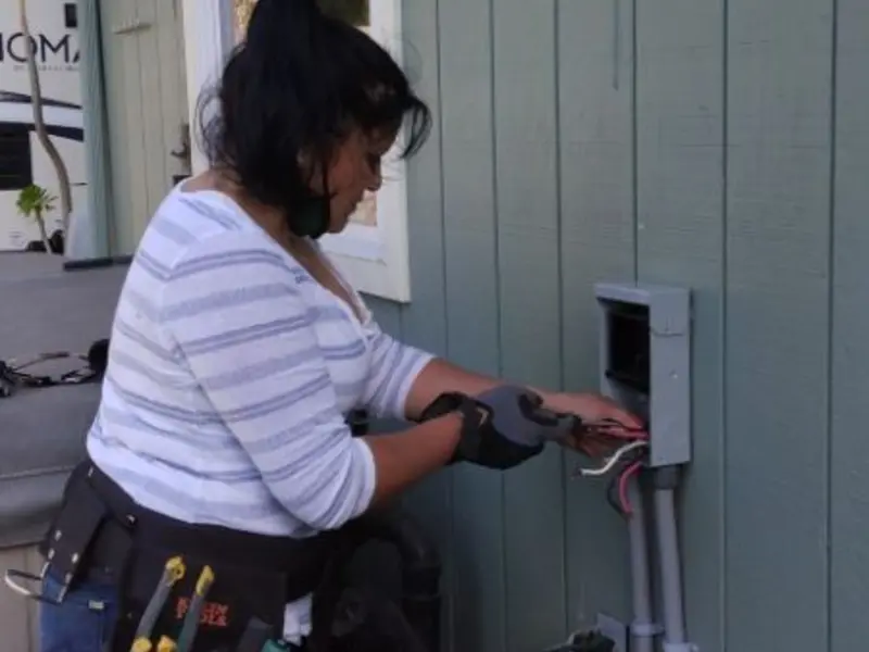 Licensed electrician wiring an exterior subpanel in West Perrine