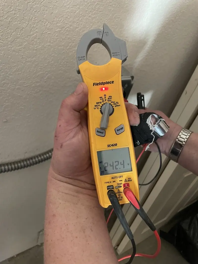 Voltage testing with clamp meter during Recessed Lighting Installation in West Perrine